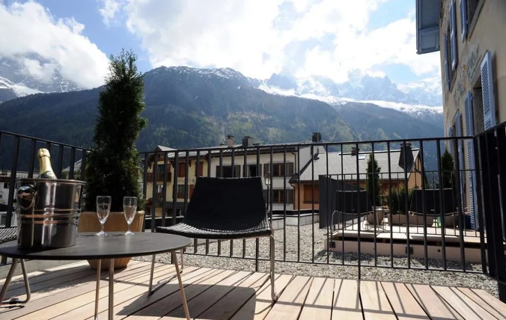 Hotel terrace with champagne bucket and mountain view, Hotel Les Lanchers.
