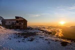 tete rousse refuge at sunset scaled
